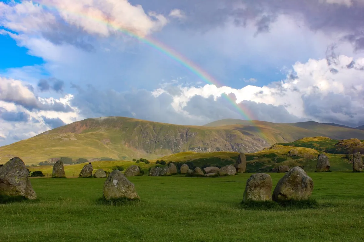 Castlerigg Stone Circle under a rainbow with Blencathra beyond