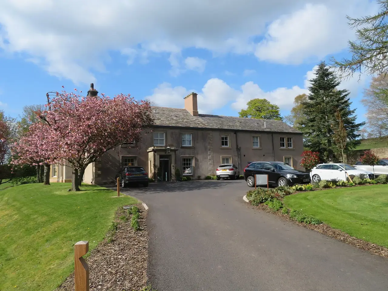The drive and front of Farlam Hall in spring blossom