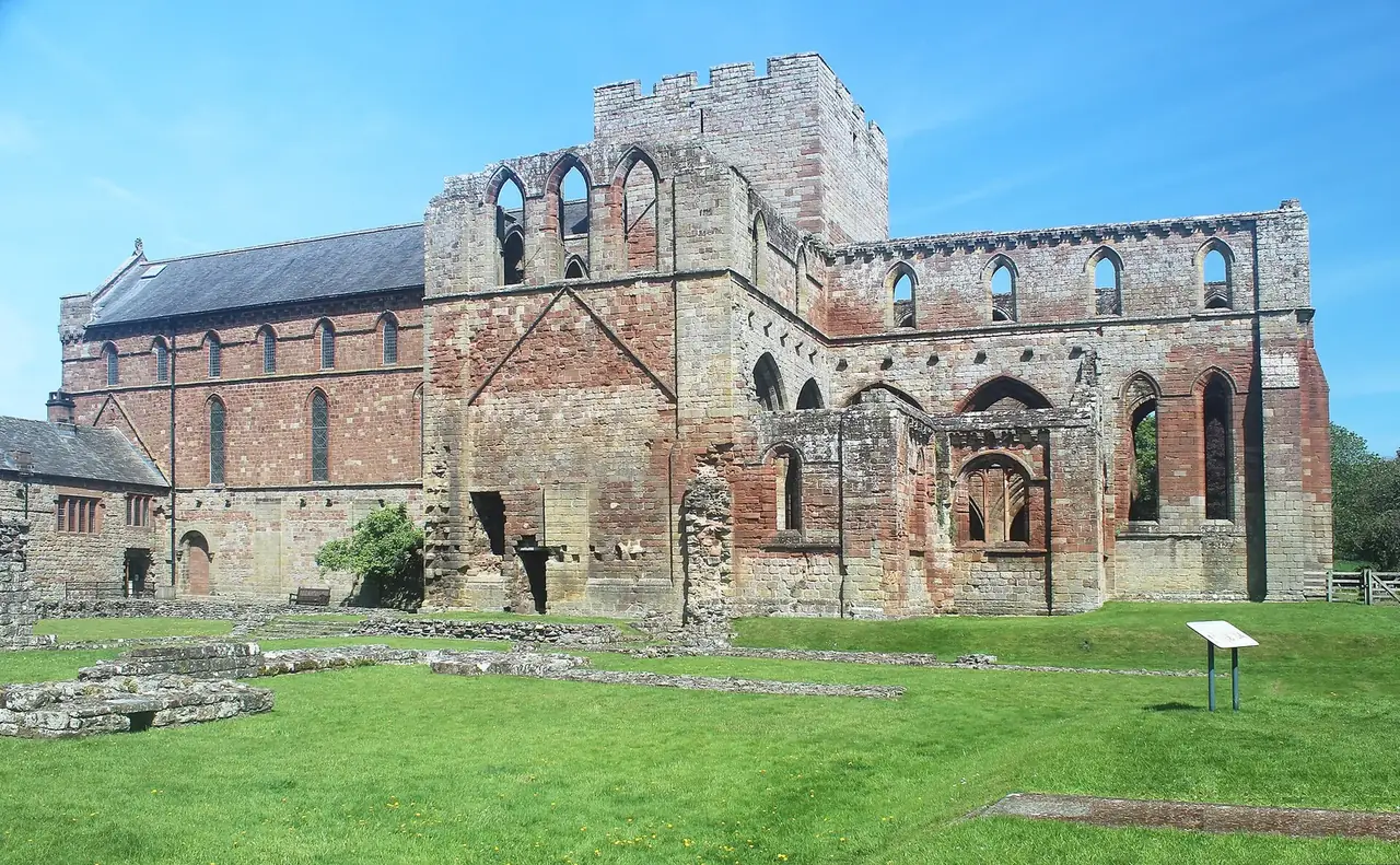 Lanercost Priory's red sandstone ruins and church from the south-east