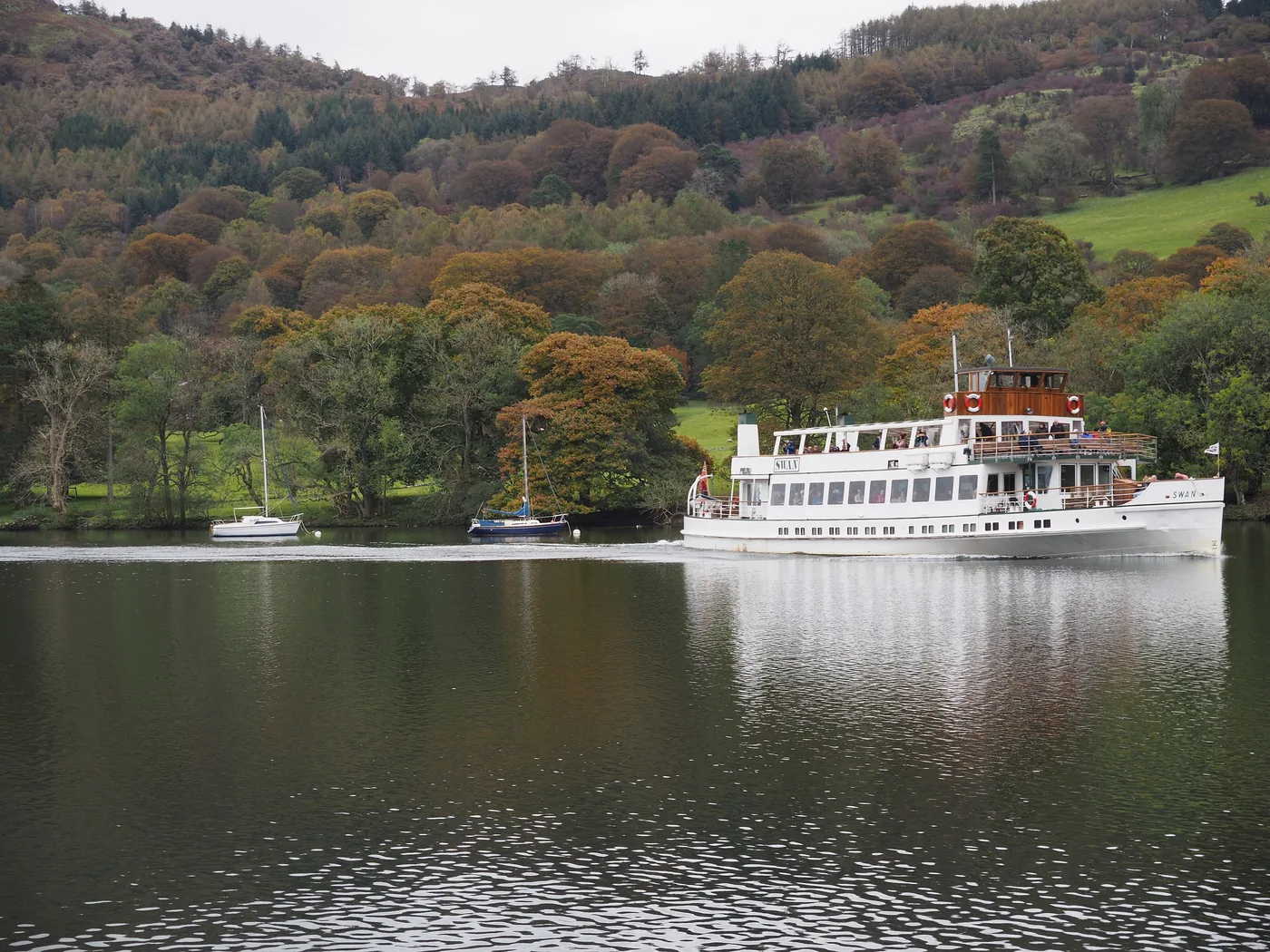 MV Swan on Windermere with the autumn shore behind